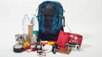A disaster go bag with key supplies, including bottled water, snacks, and a first aid kit